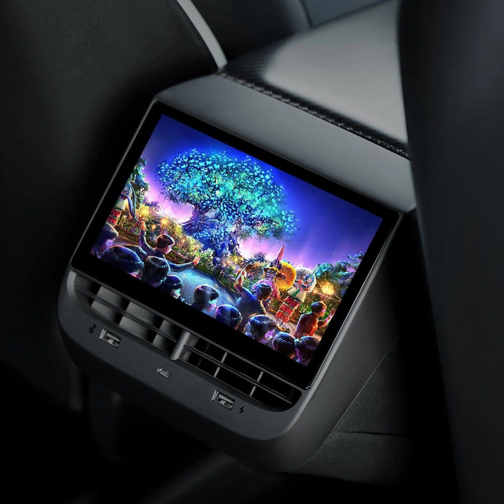 A rear entertainment display mounted behind a Tesla front seat